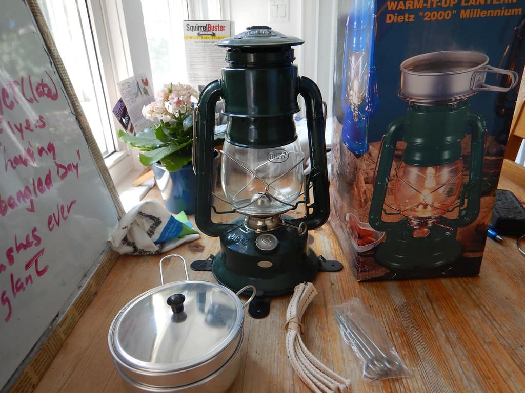 A lantern lighting a campsite after dark